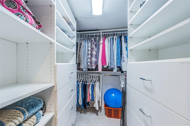 walk in closet with tile patterned floors