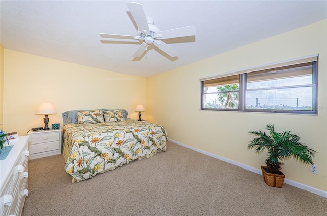 carpeted bedroom with ceiling fan, baseboards, and vaulted ceiling