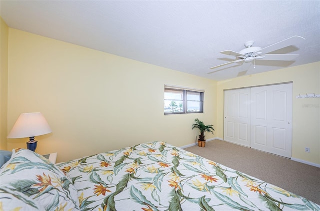 carpeted bedroom featuring a closet, a ceiling fan, and baseboards