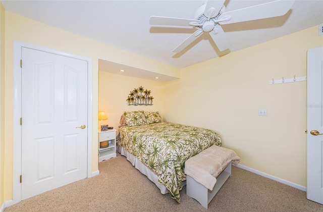 bedroom with light carpet, ceiling fan, and baseboards