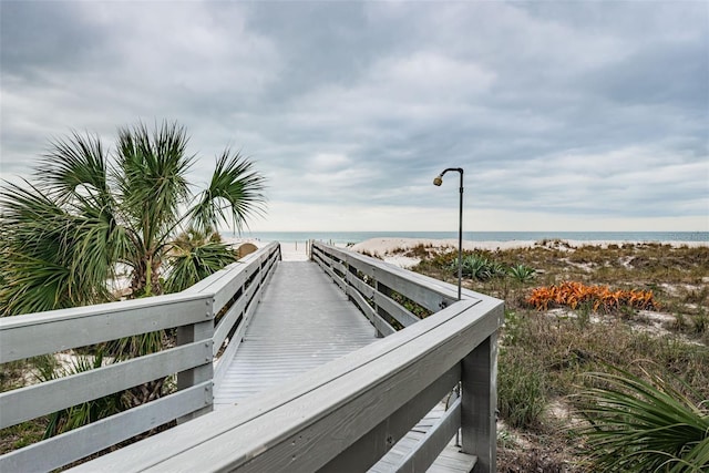 view of community with a beach view and a water view