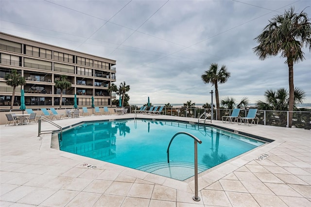 pool featuring a patio area and fence