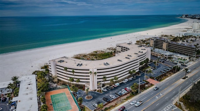 birds eye view of property with a beach view and a water view