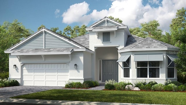 view of front of house featuring a garage, a front lawn, decorative driveway, and stucco siding