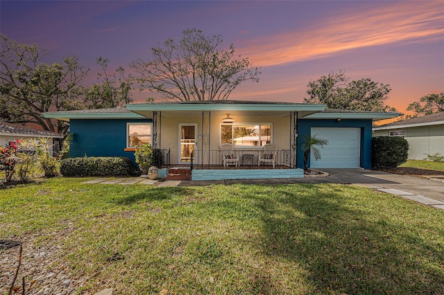 view of front of property featuring covered porch, a front lawn, an attached garage, and stucco siding