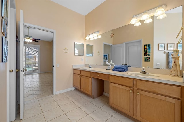 bathroom with double vanity, a sink, a ceiling fan, and tile patterned floors