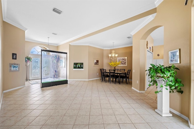 entryway with light tile patterned floors, baseboards, visible vents, ornamental molding, and a chandelier