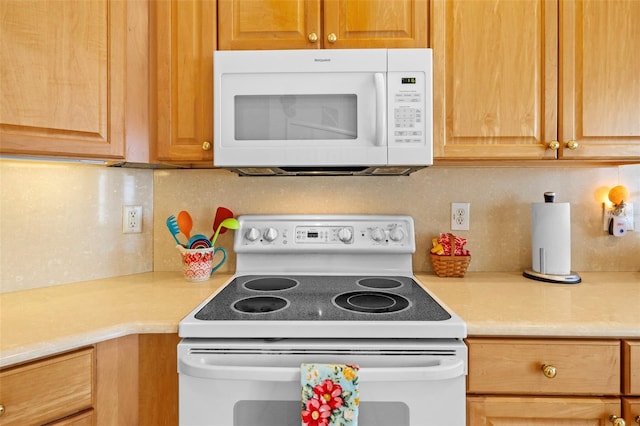 kitchen with light countertops, white appliances, and decorative backsplash