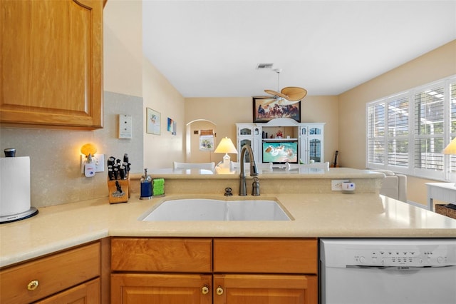 kitchen with visible vents, open floor plan, white dishwasher, light countertops, and a sink