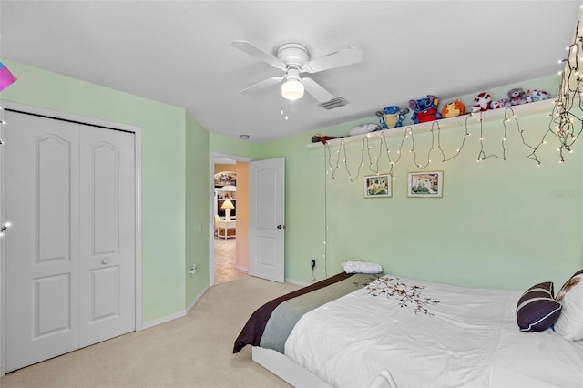 bedroom with baseboards, a ceiling fan, visible vents, and light colored carpet