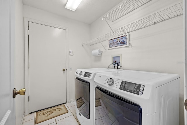 laundry room with laundry area, light tile patterned floors, and independent washer and dryer