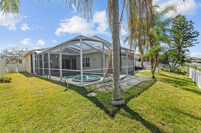 rear view of property featuring a yard, a fenced backyard, a fenced in pool, and a lanai