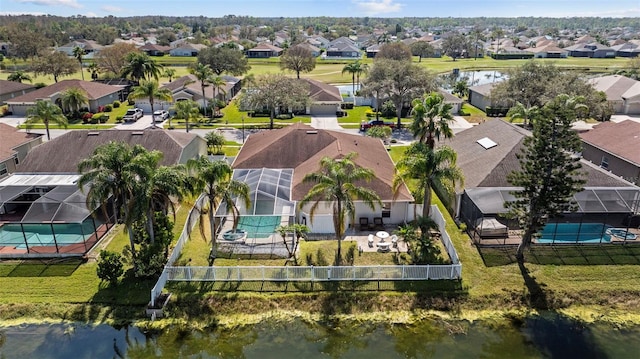 drone / aerial view with a water view and a residential view