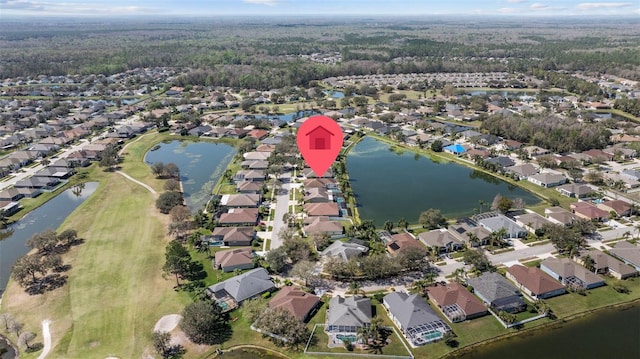 drone / aerial view with a residential view and a water view