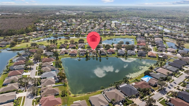 birds eye view of property with a water view and a residential view