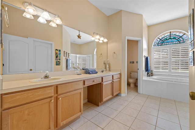 5117 Spectacular Bid Dr, Wesley Chapel, FL 33544 - bathroom featuring toilet, tile patterned flooring, double vanity, a stall shower, and a garden tub