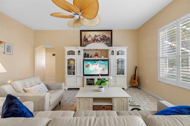 5117 Spectacular Bid Dr, Wesley Chapel, FL 33544 - living area with arched walkways, light floors, plenty of natural light, and a ceiling fan