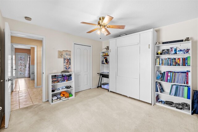 5117 Spectacular Bid Dr, Wesley Chapel, FL 33544 - bedroom with light colored carpet, ceiling fan, and light tile patterned floors