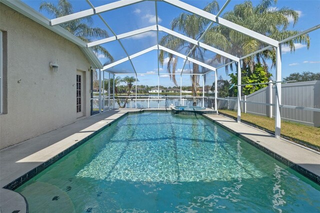 5117 Spectacular Bid Dr, Wesley Chapel, FL 33544 - view of swimming pool with a water view, a pool with connected hot tub, a patio, and fence