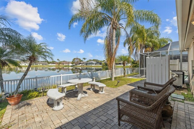 5117 Spectacular Bid Dr, Wesley Chapel, FL 33544 - view of patio with a water view, a fenced backyard, and a lanai