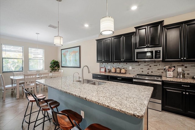 kitchen featuring stainless steel appliances, a sink, and dark cabinets