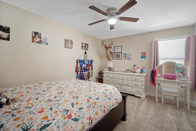 bedroom featuring light carpet, baseboards, a ceiling fan, and a textured ceiling