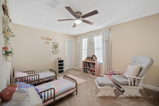 living area with ceiling fan, carpet, visible vents, and baseboards