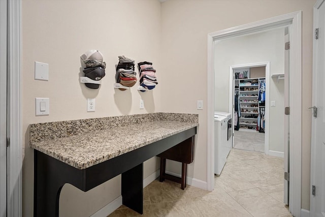 laundry area with light tile patterned floors, laundry area, independent washer and dryer, and baseboards