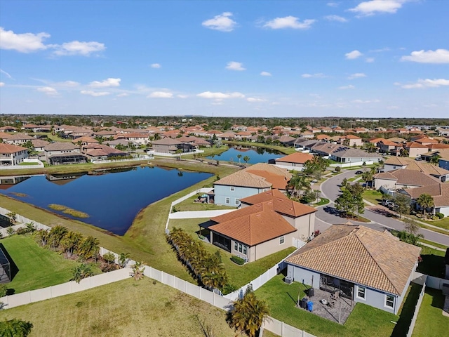 drone / aerial view with a water view and a residential view