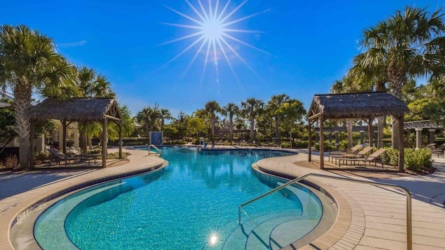 community pool with a patio and a gazebo