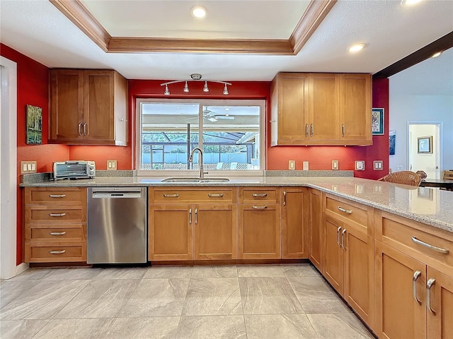 kitchen featuring a sink, brown cabinetry, a raised ceiling, and stainless steel dishwasher