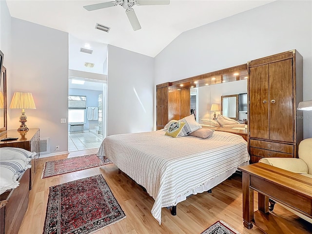 bedroom featuring lofted ceiling, light wood finished floors, and visible vents