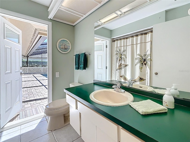 bathroom featuring a shower with curtain, vanity, toilet, and tile patterned floors