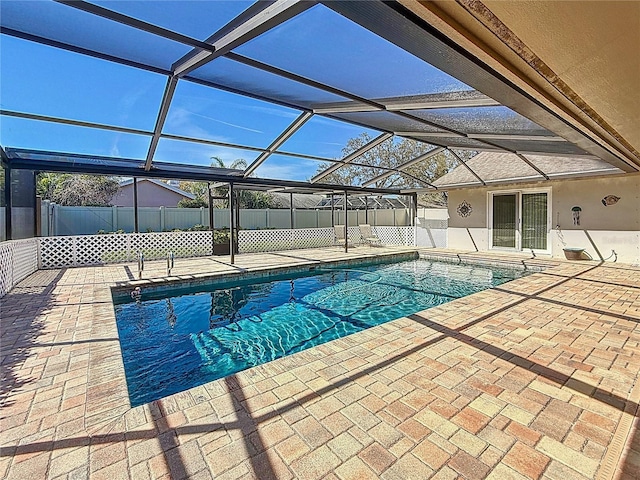 view of pool featuring a patio, fence, a fenced in pool, and a lanai