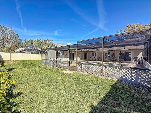 view of yard featuring a lanai, fence, a fenced in pool, and a patio