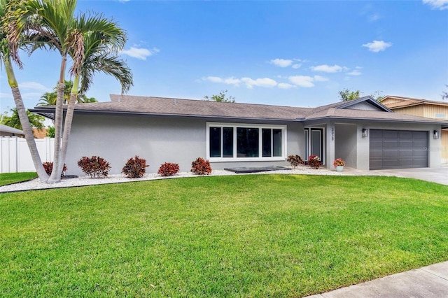 single story home with a front lawn, fence, an attached garage, and stucco siding