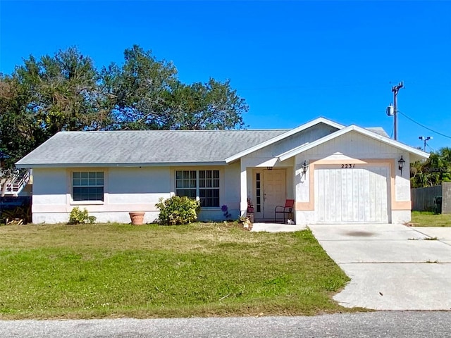 ranch-style home featuring a front yard, concrete driveway, an attached garage, and stucco siding