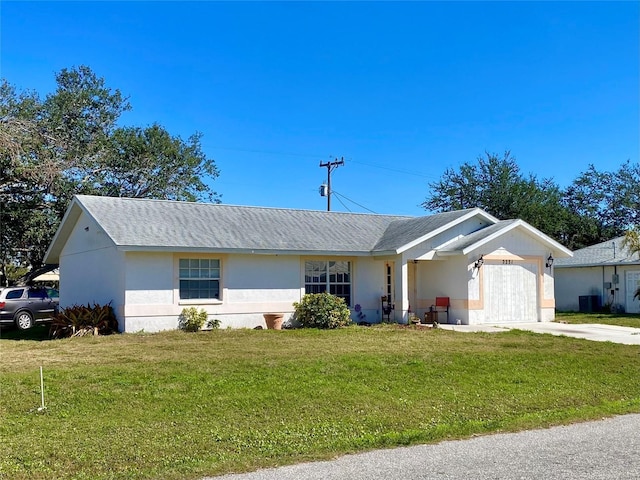 single story home with a garage, a front yard, driveway, and stucco siding