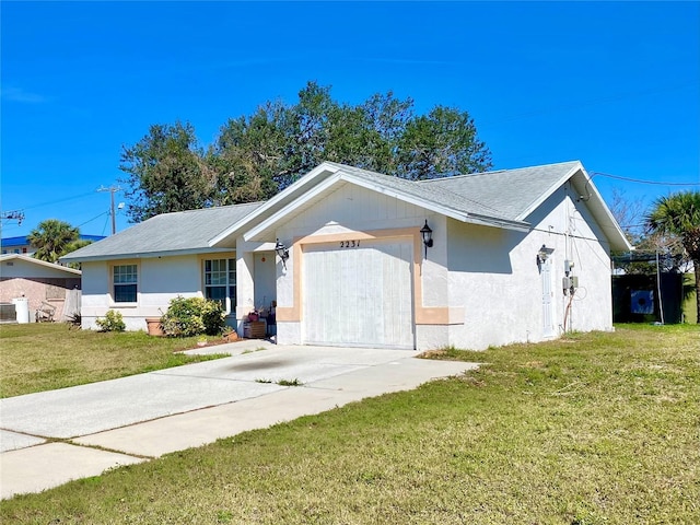 view of front of house with concrete driveway, an attached garage, a front lawn, and stucco siding