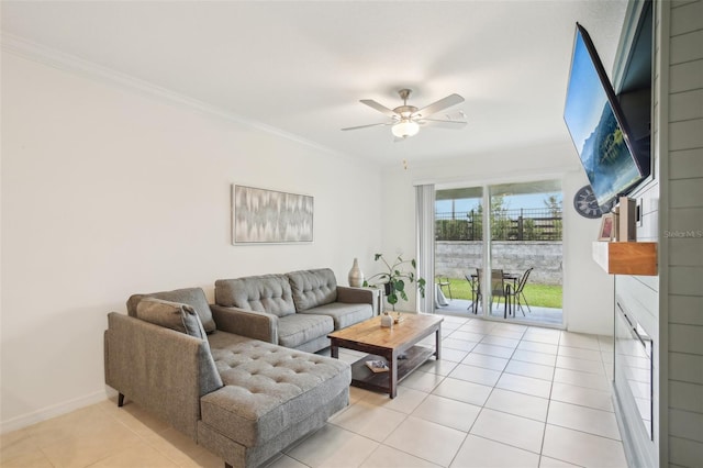 living room featuring ornamental molding, ceiling fan, baseboards, and light tile patterned floors