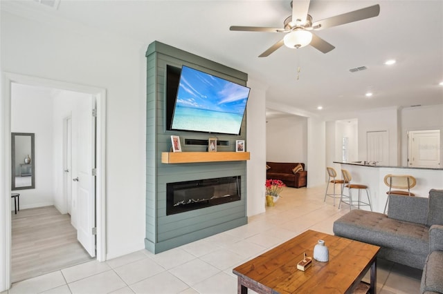 living room with recessed lighting, visible vents, a large fireplace, light tile patterned flooring, and ceiling fan