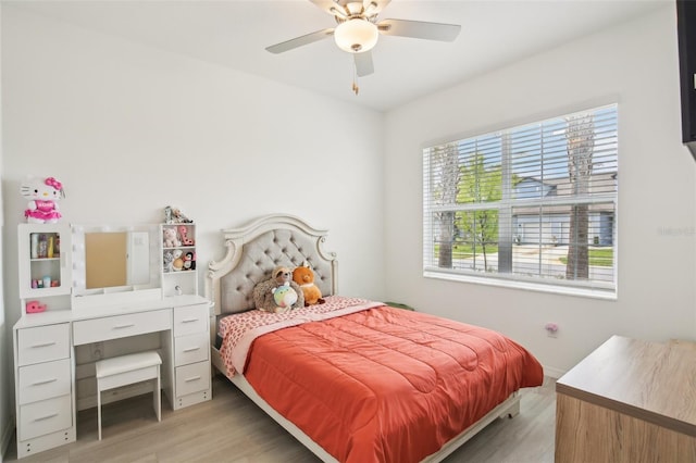 bedroom with light wood-type flooring and a ceiling fan