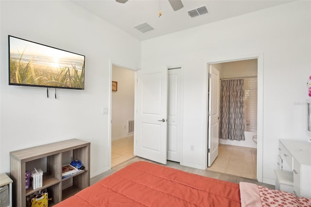 bedroom with ensuite bath, tile patterned flooring, and visible vents