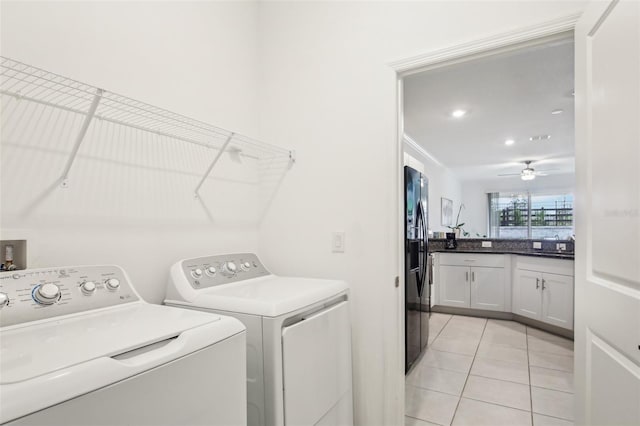 clothes washing area featuring light tile patterned floors, ceiling fan, laundry area, and washing machine and clothes dryer