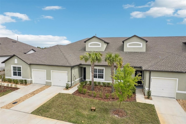 view of front of property with driveway, an attached garage, roof with shingles, and stucco siding