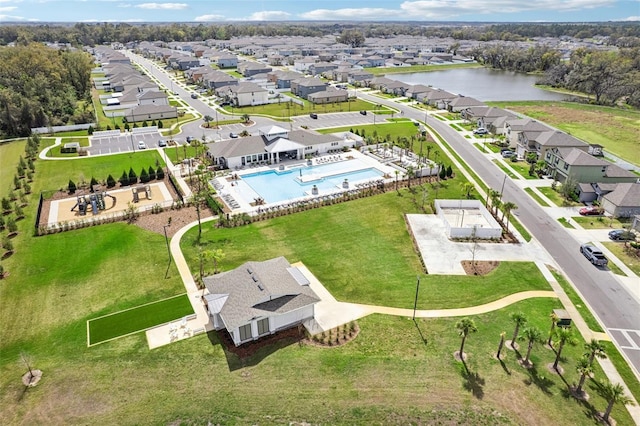 birds eye view of property with a water view and a residential view