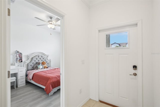 bedroom featuring light wood finished floors, baseboards, and a ceiling fan