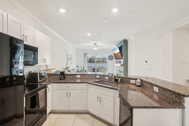 kitchen featuring black appliances, a toaster, ornamental molding, and a sink