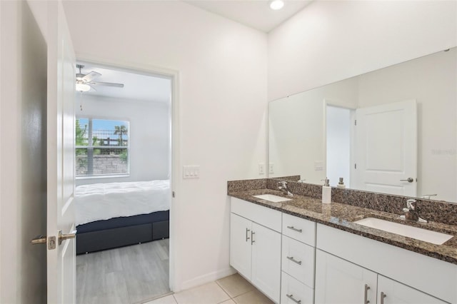 bathroom featuring ceiling fan, double vanity, tile patterned flooring, and a sink