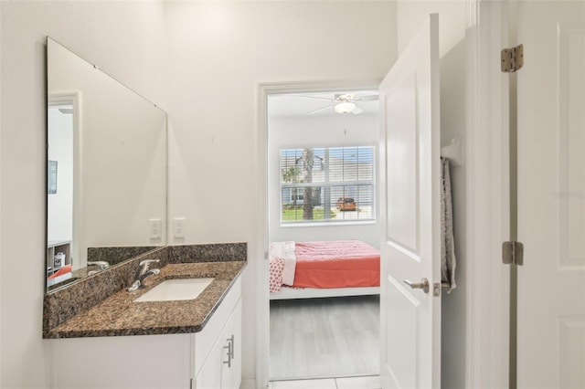 bathroom featuring ensuite bathroom, vanity, and a ceiling fan